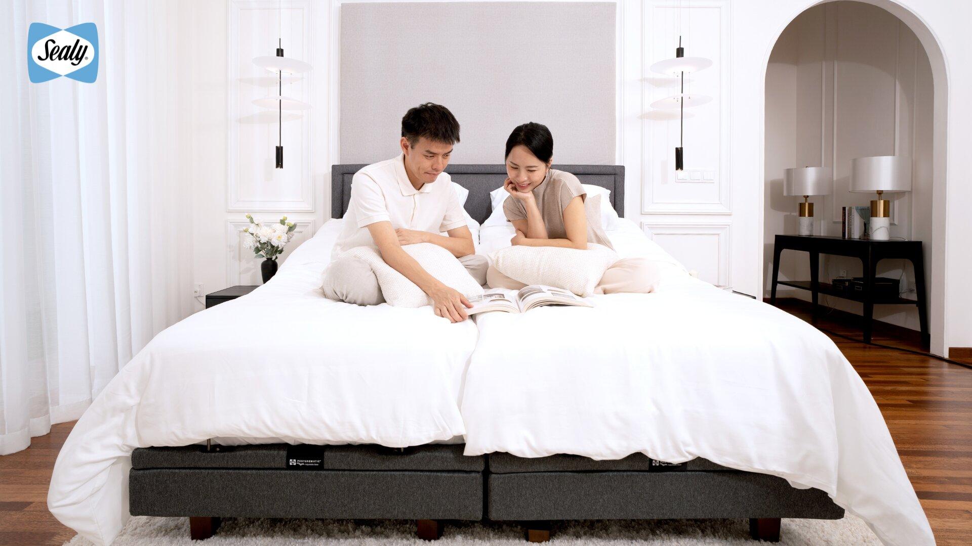 The Science Behind Sealy's Adjustable Beds: Engineered to Move, Designed to Support 4 Couple sitting up to relax and read on a Sealy Posturpedic Adjustable