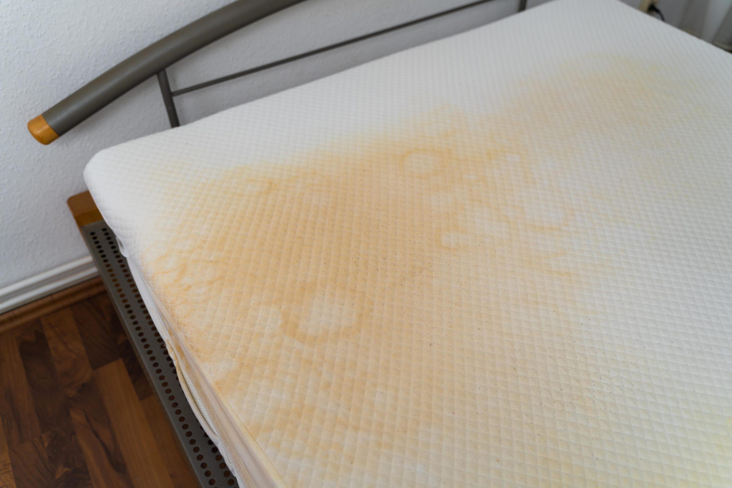 How Long Does A Mattress Last and When to Replace It 6 An old mattress with yellow stains and worn fabric