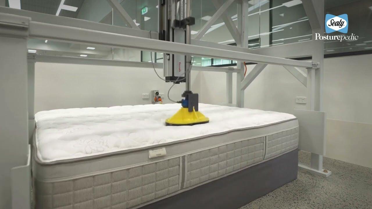 How Long Does A Mattress Last and When to Replace It 8 Sealy Cornell durability test rig in a NATA-accredited lab, pressing a mattress to prove how long it lasts