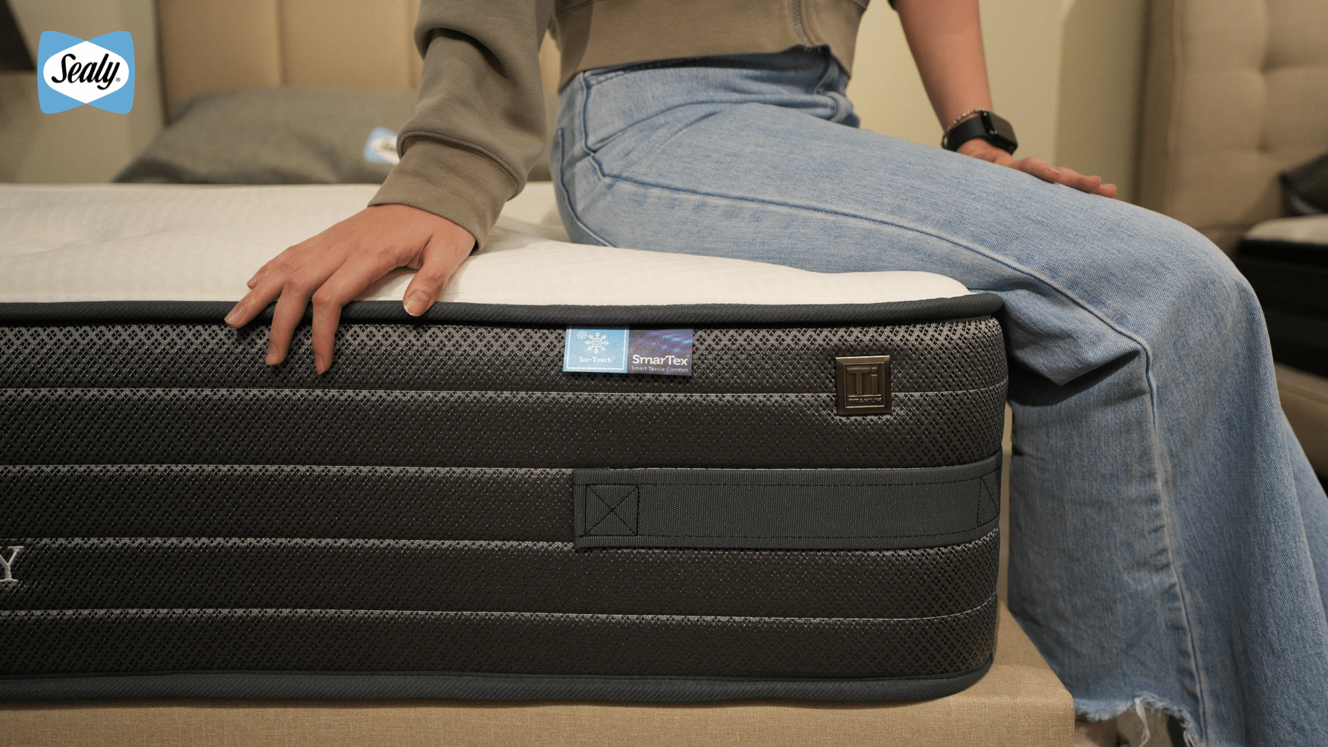 What Should Heavy Sleepers Look for in a Mattress? 8 Person sitting on the edge of a Sealy mattress to test its edge support